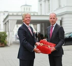 Foto: Peter J. Leitgeb (l.) händigt Tim Hansen, dem neuen Hoteldirektor des Grand Hotels Heiligendamm,  symbolisch den Schlüssel für die Weiße Stadt am Meer aus
